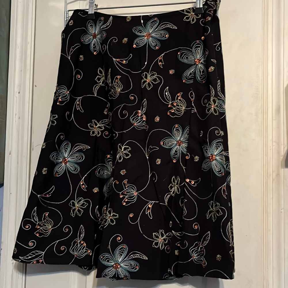 Covington size 12 black floral skirt with sequins. Gently worn